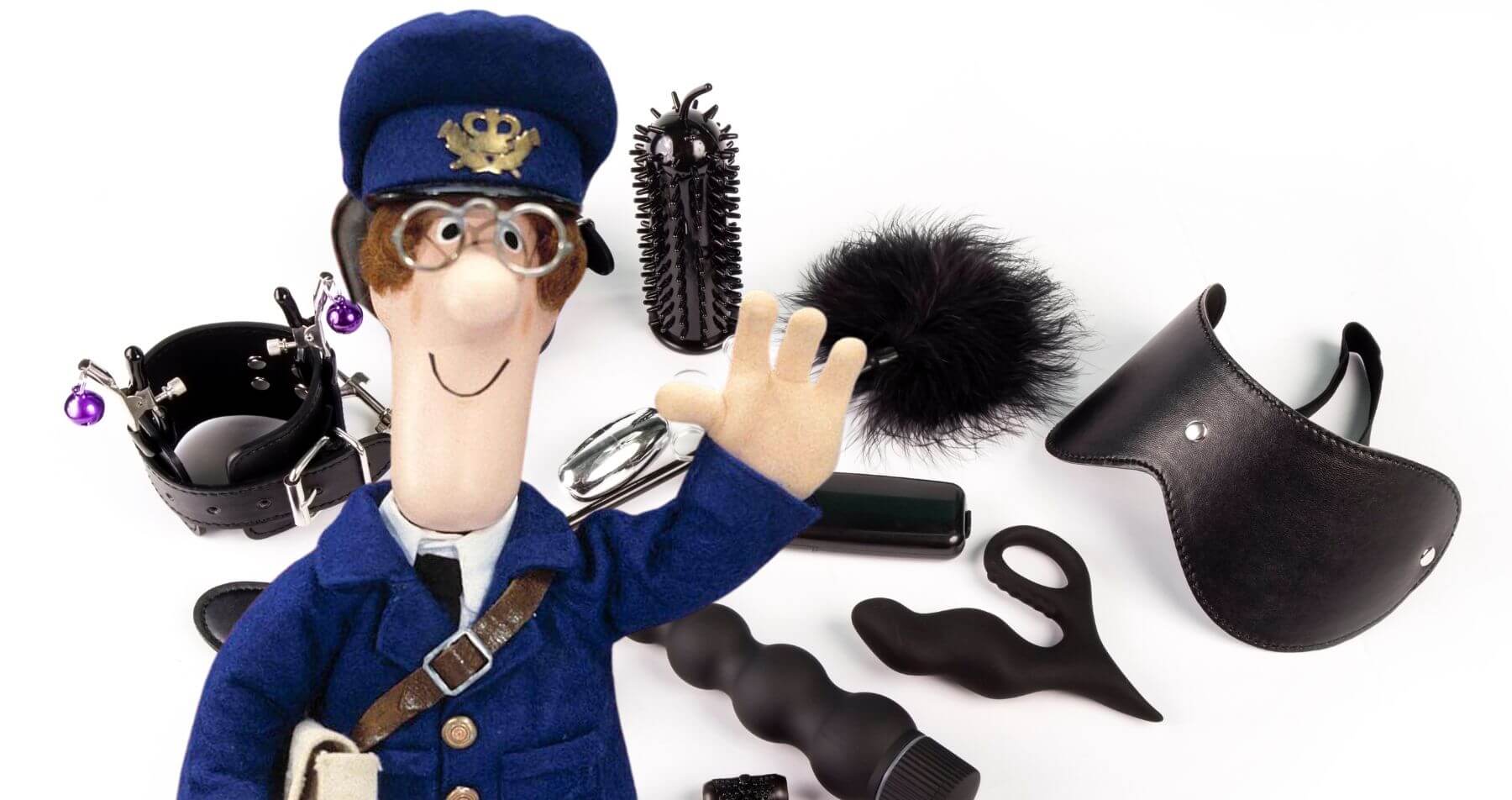 Postman Pat stood in front of some black and white sex toys.