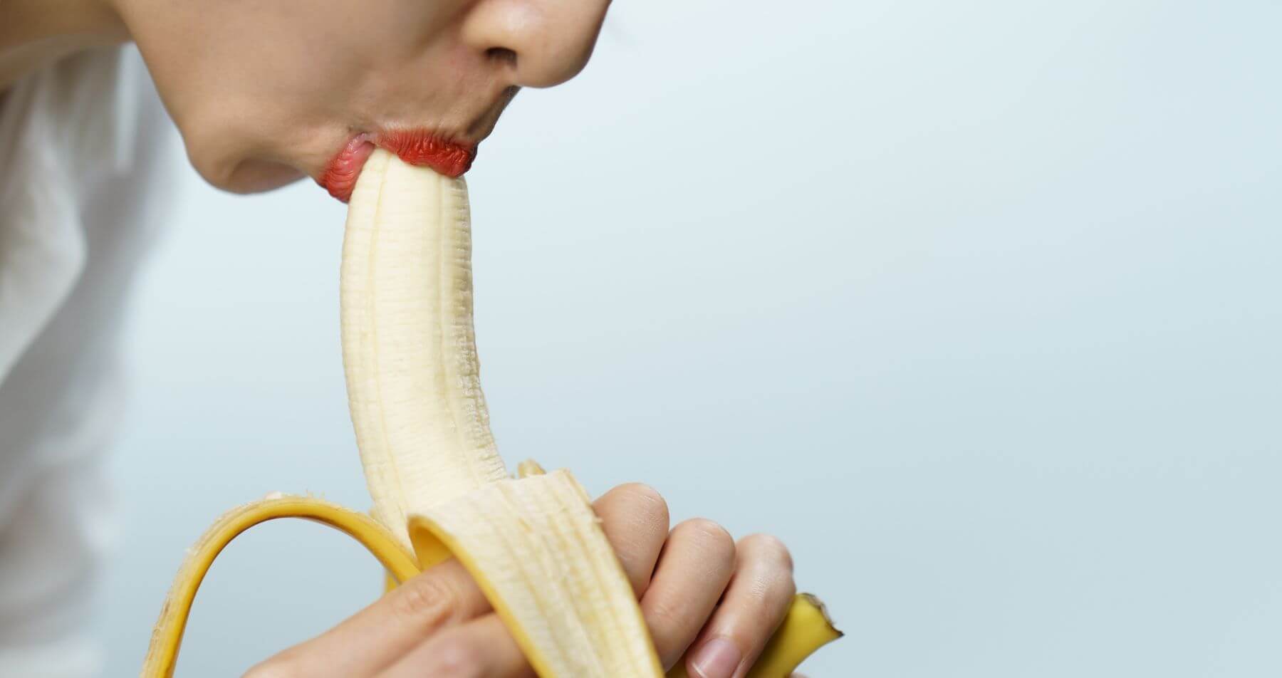 Woman fellating a banana